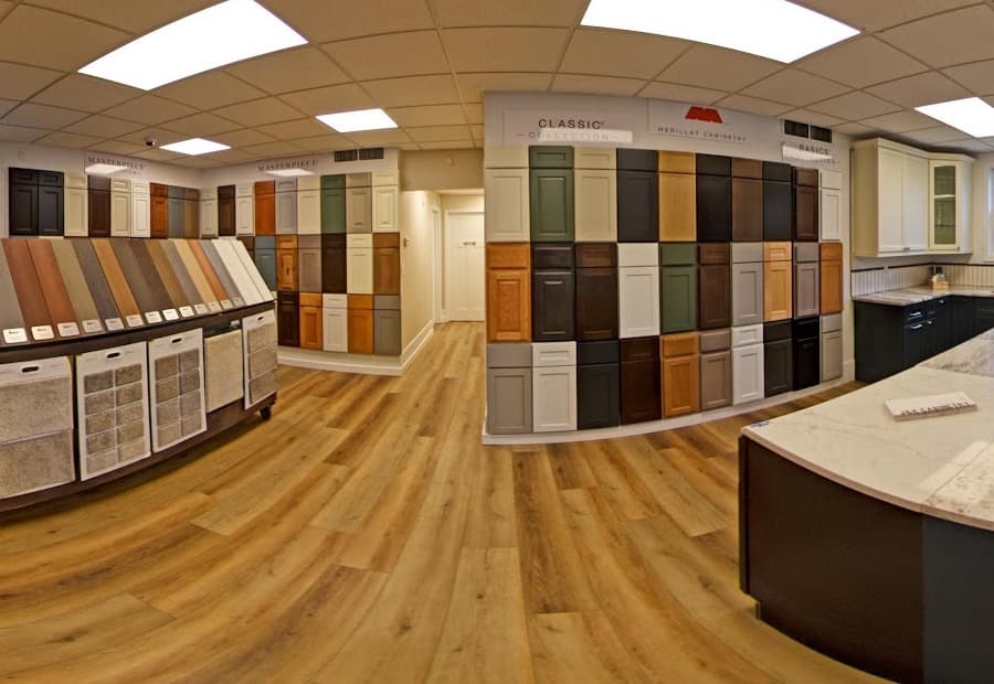 Cabinet door samples arranged by collection — Merillat Classic, Merillat Basics and Masterpiece — above luxury vinyl plank flooring, with countertop samples alongside.